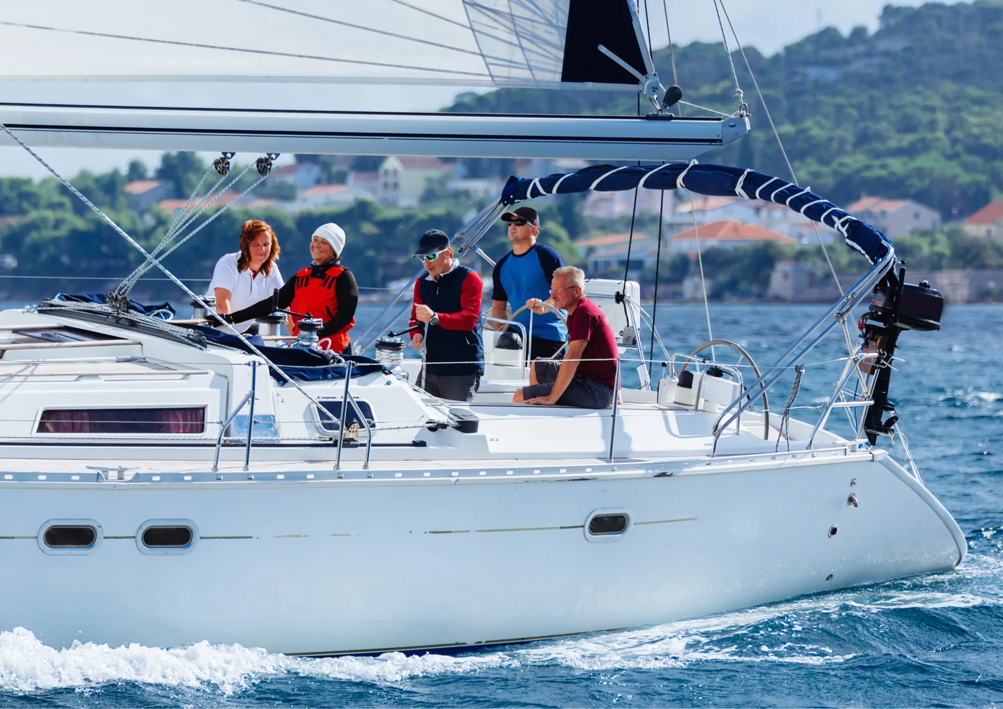 Sailing crew working together aboard a yacht at sea